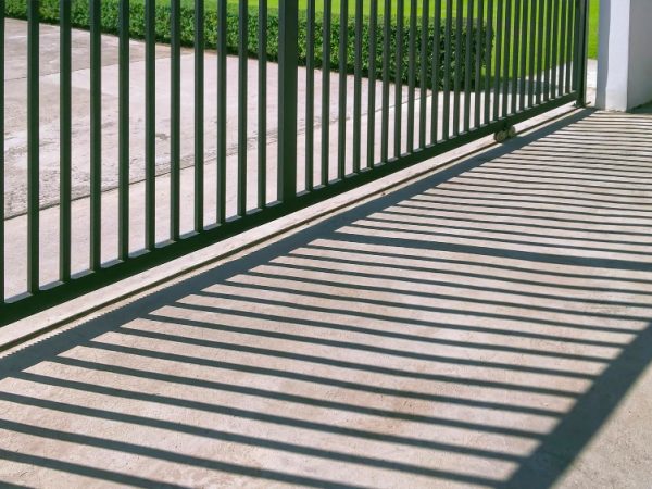 sunlight-shadow-surface-automatic-sliding-metal-fence-gate-front-modern-house